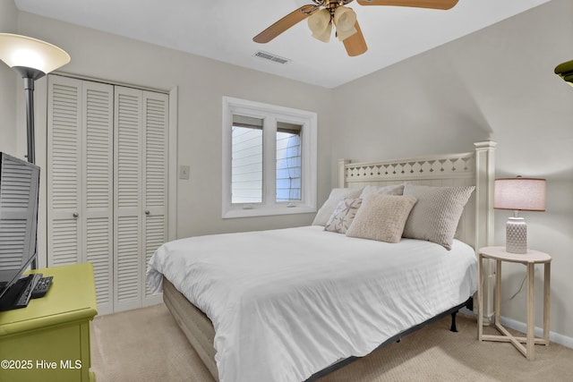 bedroom featuring visible vents, a closet, baseboards, carpet flooring, and ceiling fan