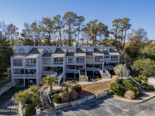 back of property featuring stairway