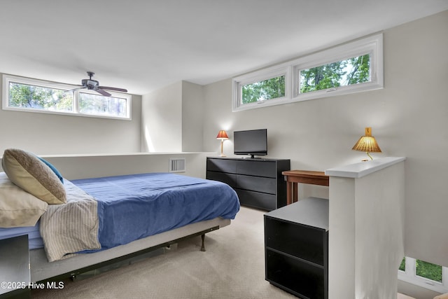 bedroom featuring ceiling fan, light carpet, and visible vents