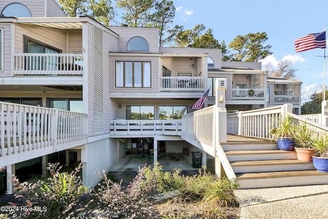 back of house with stairs