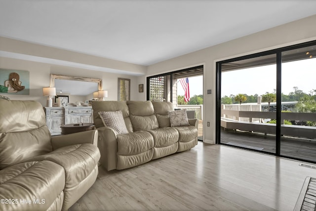 living room featuring light wood-style flooring and visible vents