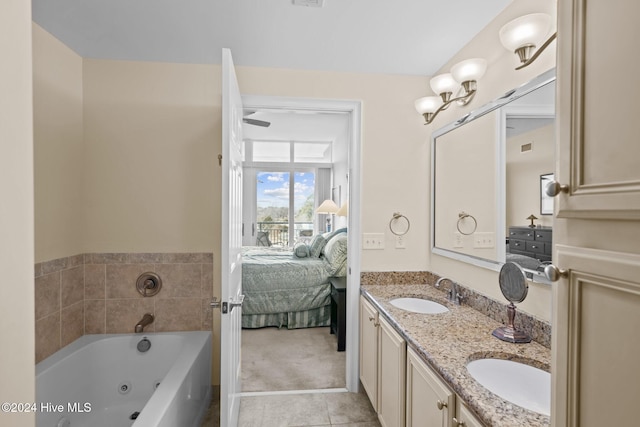 bathroom featuring tile patterned floors, vanity, and a washtub