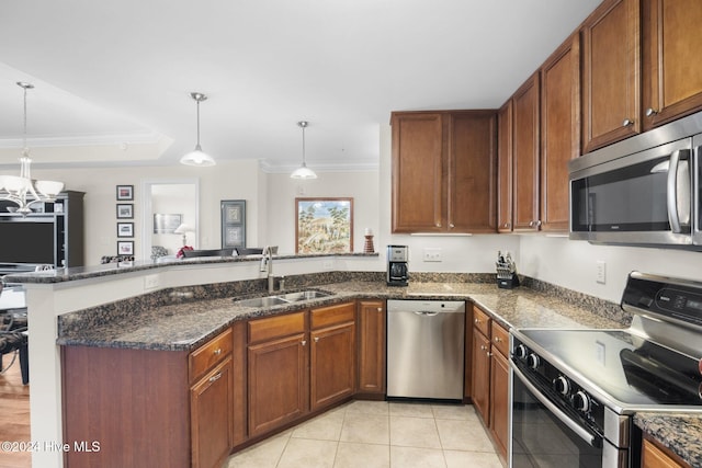 kitchen featuring sink, kitchen peninsula, decorative light fixtures, light tile patterned floors, and appliances with stainless steel finishes