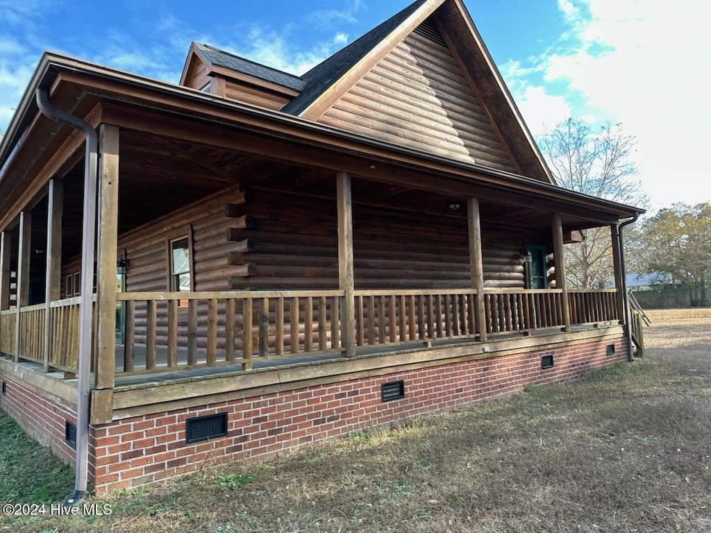 view of side of home with covered porch