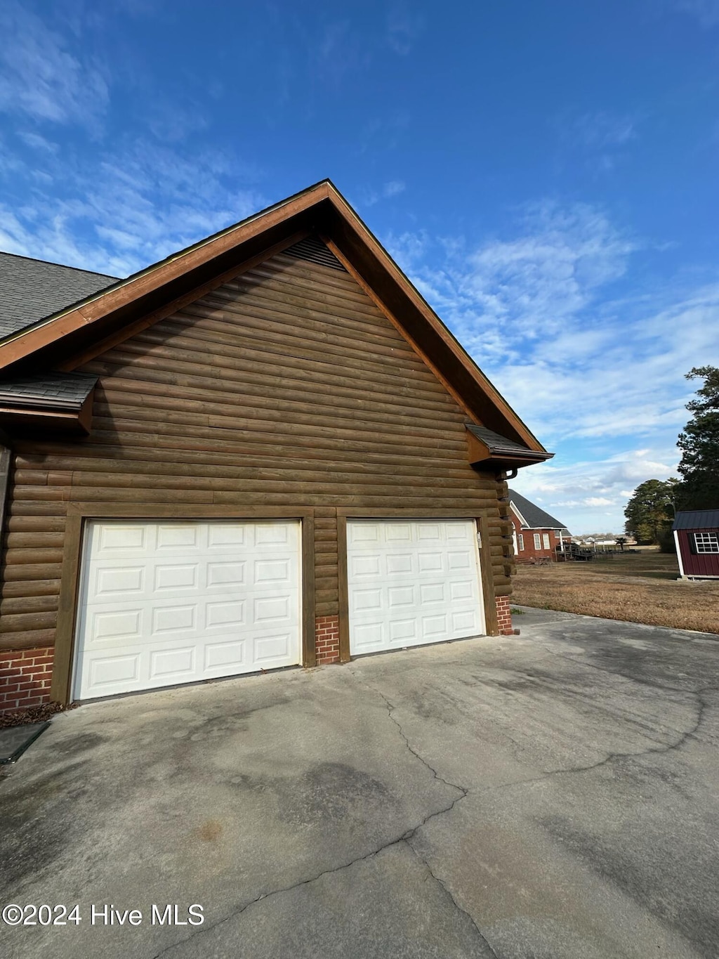 view of side of home with a garage and an outdoor structure