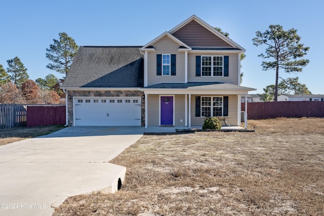 view of property featuring covered porch and a garage