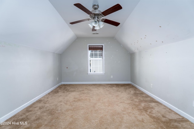 bonus room featuring ceiling fan, light colored carpet, and vaulted ceiling