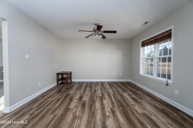 spare room featuring ceiling fan and dark wood-type flooring