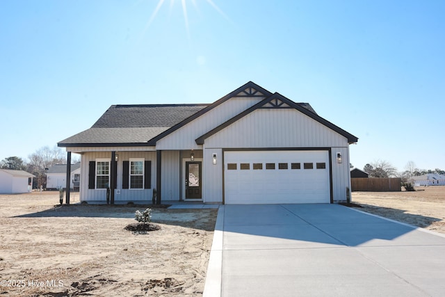 view of front of property with covered porch and a garage