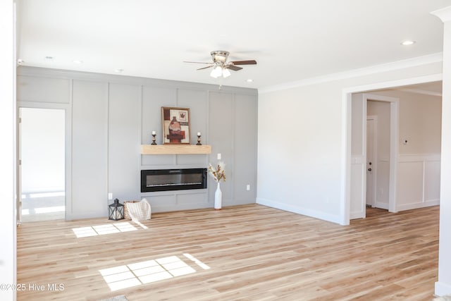 unfurnished living room with light wood-type flooring, ceiling fan, and crown molding