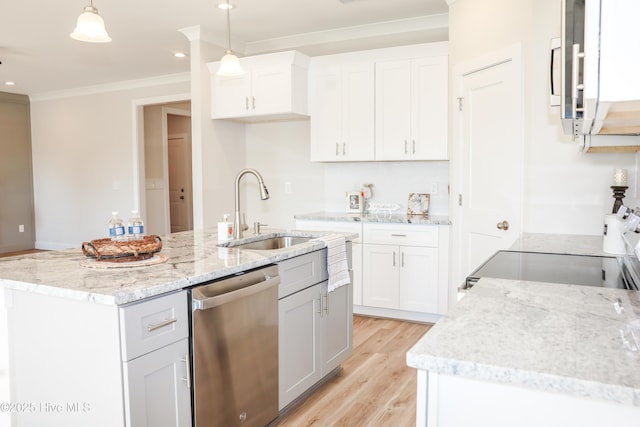 kitchen with a kitchen island with sink, white cabinets, sink, decorative light fixtures, and stainless steel appliances