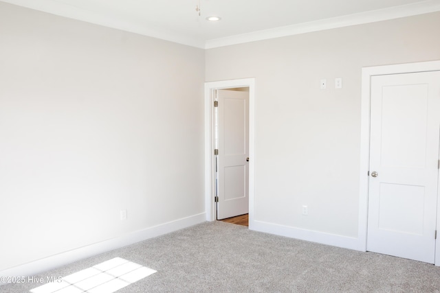 carpeted spare room with crown molding