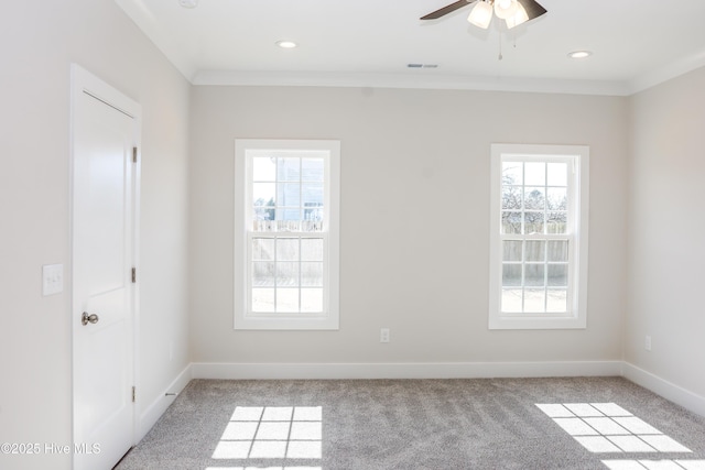 carpeted empty room featuring ceiling fan and ornamental molding