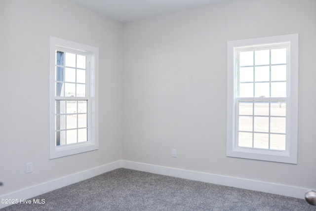 carpeted spare room featuring a healthy amount of sunlight