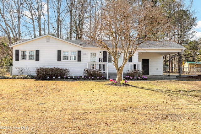 ranch-style home with a carport and a front yard