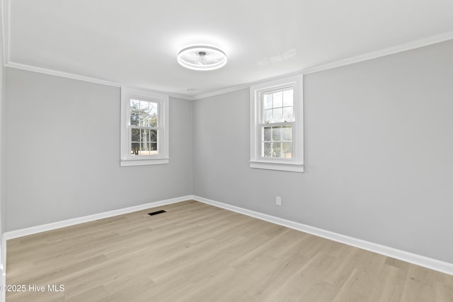 unfurnished room with ornamental molding, light hardwood / wood-style floors, and a healthy amount of sunlight