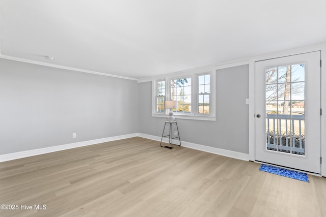 entrance foyer with crown molding and light hardwood / wood-style floors