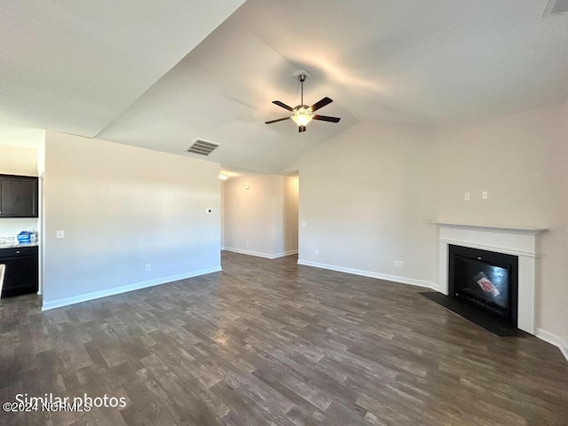 unfurnished living room featuring dark hardwood / wood-style floors, ceiling fan, and lofted ceiling