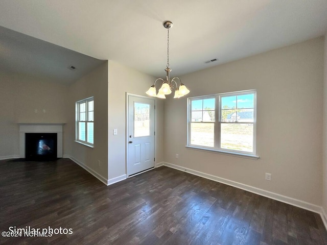 interior space with lofted ceiling, a chandelier, and dark hardwood / wood-style floors