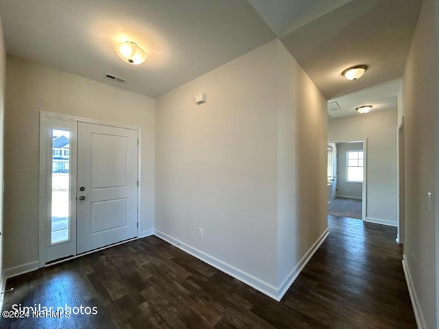 foyer entrance with dark hardwood / wood-style floors