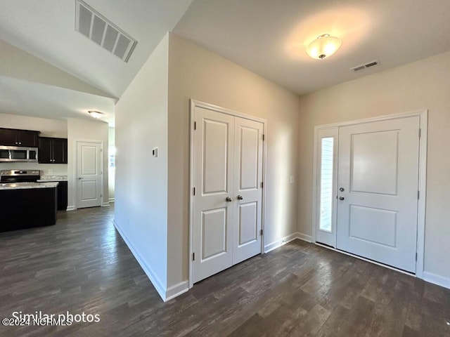 entryway with dark hardwood / wood-style flooring and lofted ceiling