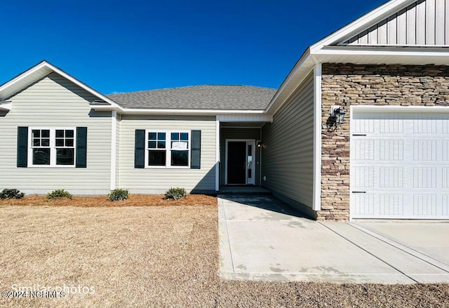 view of exterior entry with a garage