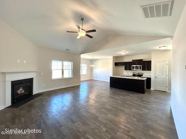 unfurnished living room with vaulted ceiling, sink, ceiling fan with notable chandelier, and dark hardwood / wood-style floors