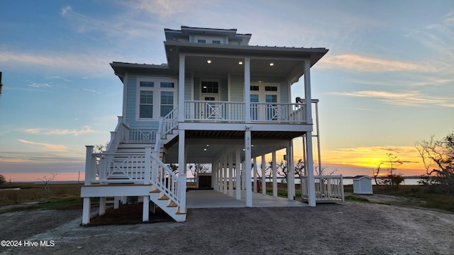 view of front of property featuring covered porch and a carport