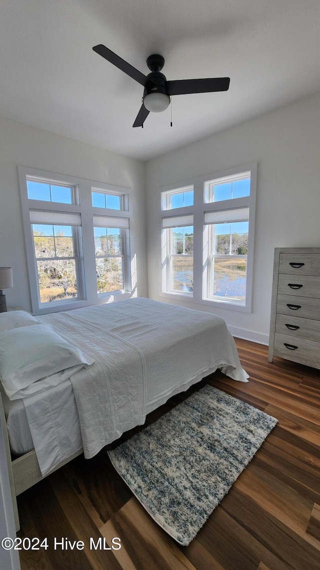 bedroom with ceiling fan and dark hardwood / wood-style flooring