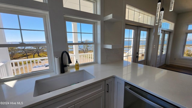 kitchen featuring a wealth of natural light, sink, and dishwasher