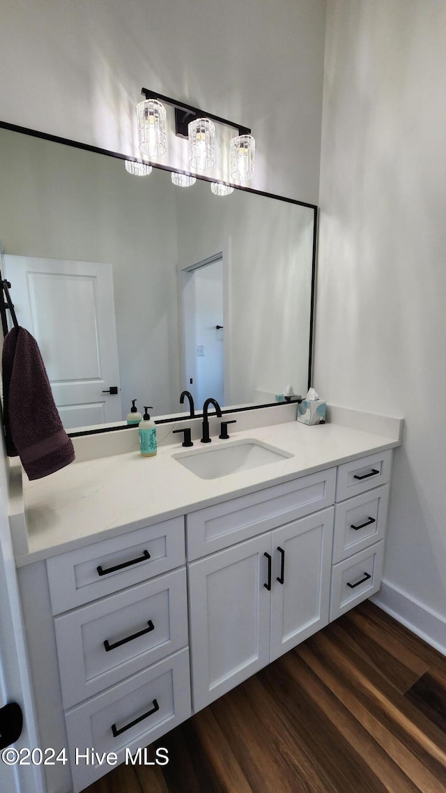 bathroom with hardwood / wood-style floors and vanity