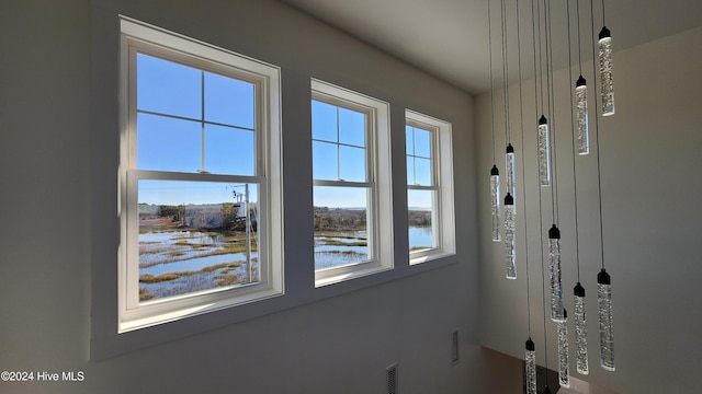 doorway with a healthy amount of sunlight and a water view