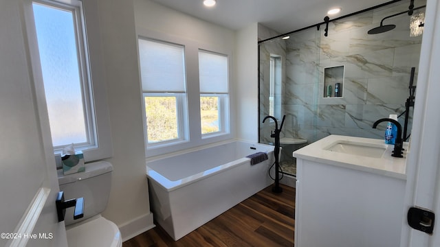 full bathroom featuring hardwood / wood-style floors, vanity, shower with separate bathtub, and toilet