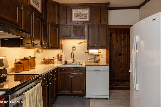 kitchen featuring dark brown cabinetry, sink, ornamental molding, white appliances, and custom exhaust hood