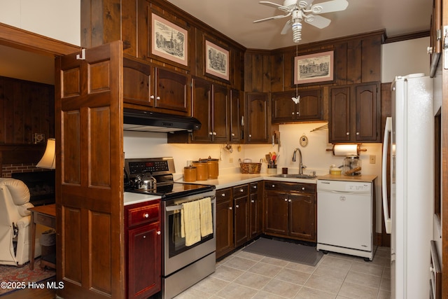 kitchen featuring white appliances, sink, ceiling fan, light tile patterned floors, and ornamental molding