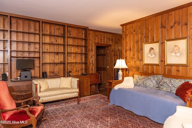 living room featuring ornamental molding and wooden walls