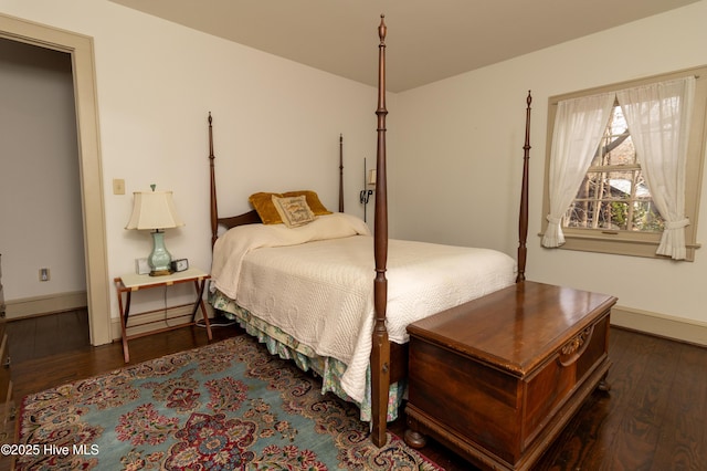 bedroom with dark hardwood / wood-style floors