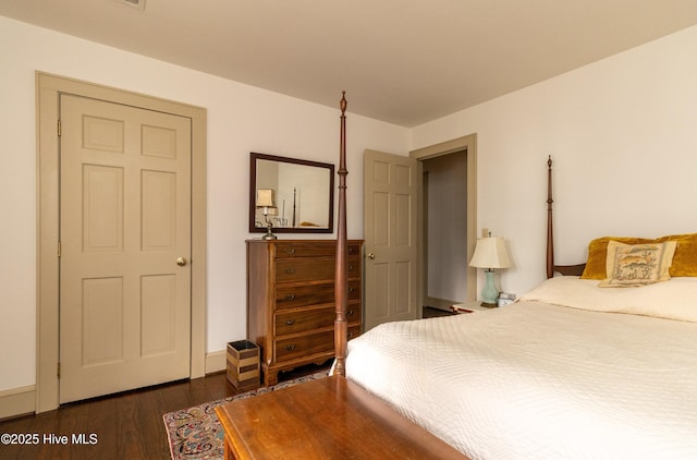 bedroom with dark wood-type flooring