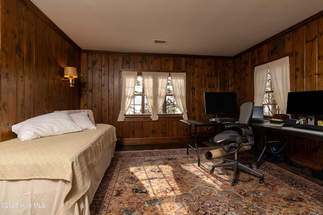 office area featuring wood walls, a healthy amount of sunlight, and ornamental molding