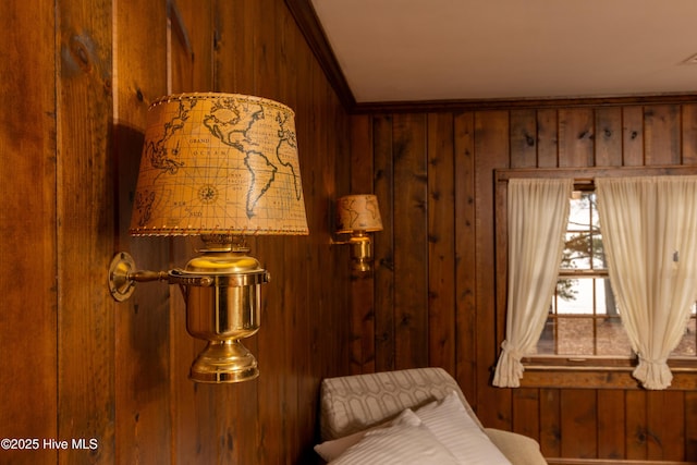 interior space with ornamental molding and wood walls