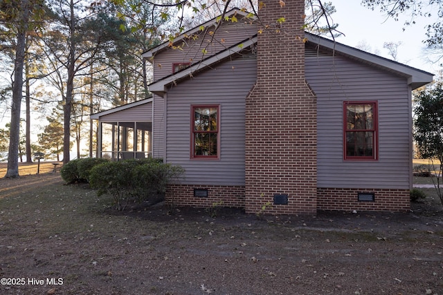 view of home's exterior with a sunroom