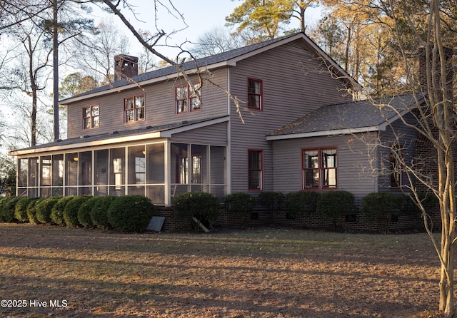 view of front of home featuring a sunroom