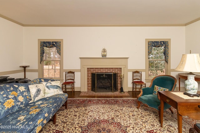 living room with a fireplace, hardwood / wood-style floors, and ornamental molding