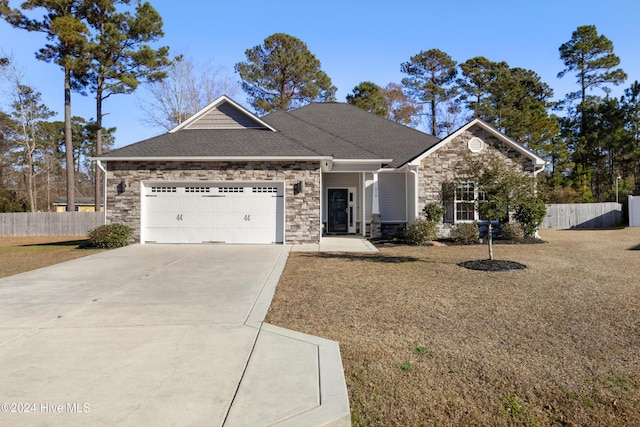 view of front of house with a front yard and a garage