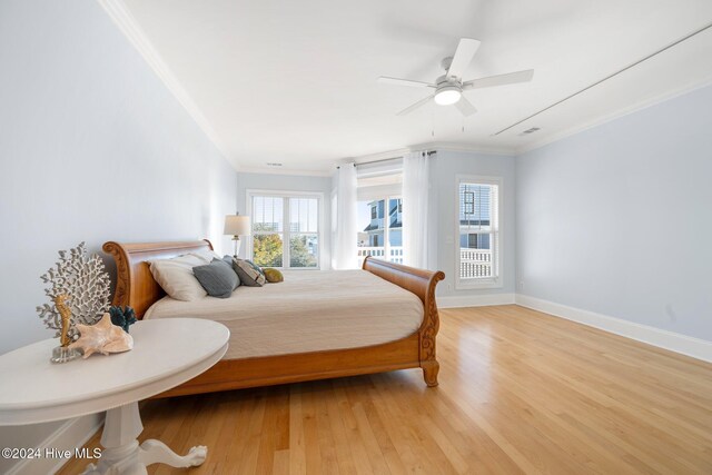 bedroom with crown molding, ceiling fan, and light hardwood / wood-style flooring