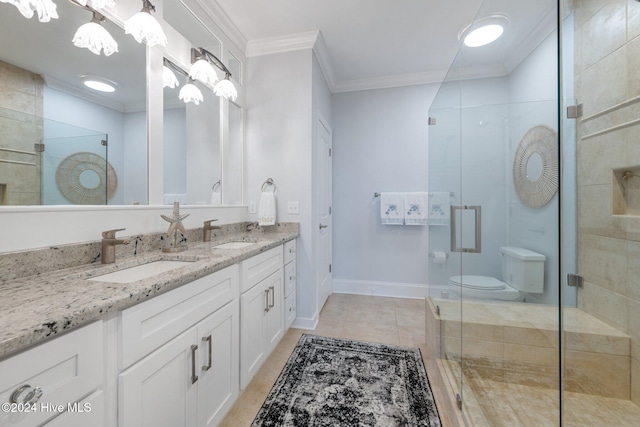 bathroom featuring crown molding, vanity, a shower with shower door, tile patterned floors, and toilet