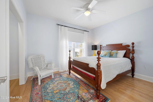 bedroom with ceiling fan and light hardwood / wood-style flooring