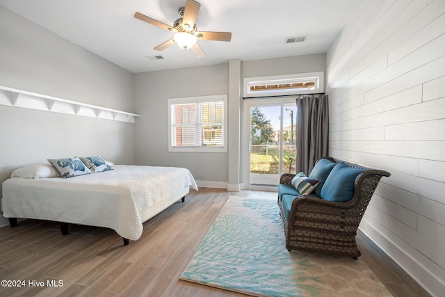 bedroom with ceiling fan, hardwood / wood-style floors, and access to outside