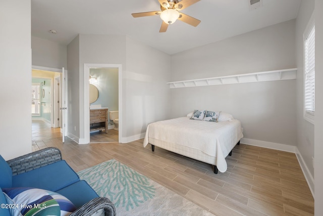 bedroom featuring ceiling fan and ensuite bath