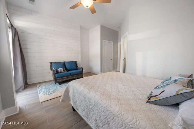 bedroom with light hardwood / wood-style floors and ceiling fan